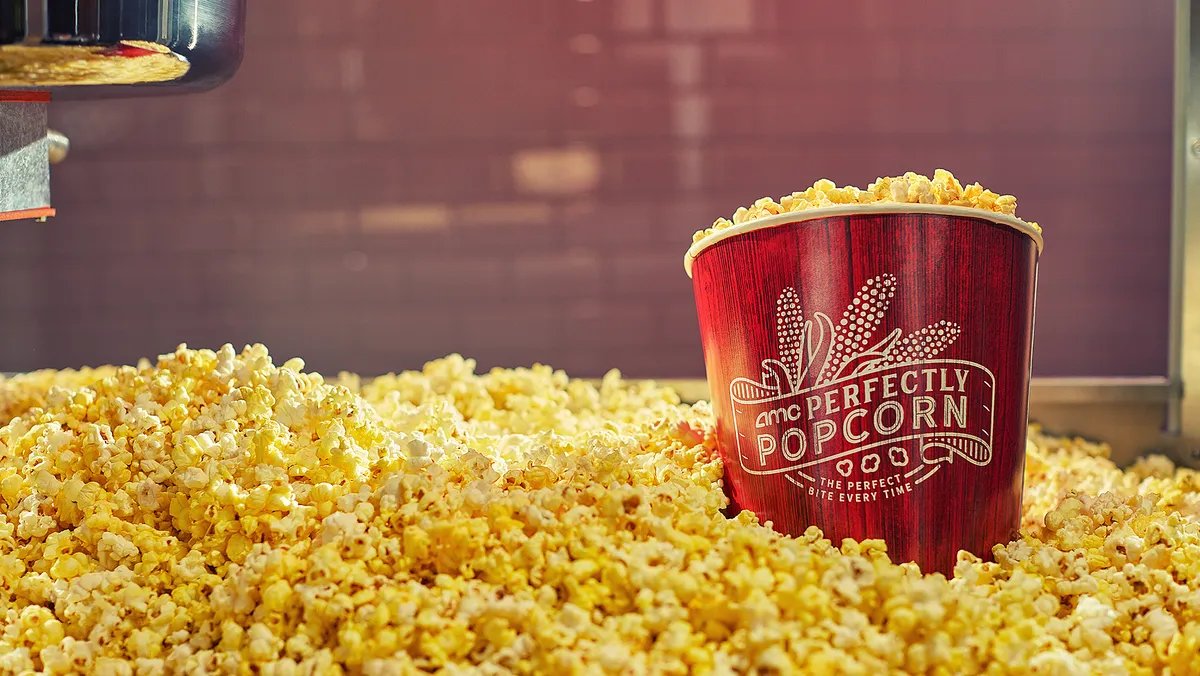 A bucket of fresh popcorn at an AMC movie theater, highlighting the new Popcorn Pass promotion.