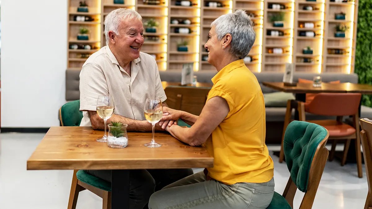 A split image showing a lively communal table on one side and a quiet, intimate dining setting on the other, representing the diverse dining preferences of different generations.