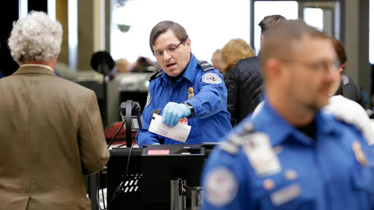 A sign at an airport reminding travelers to have their identification ready.