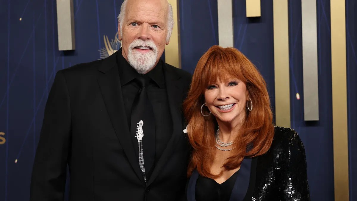 Reba McEntire and Rex Linn smiling together.