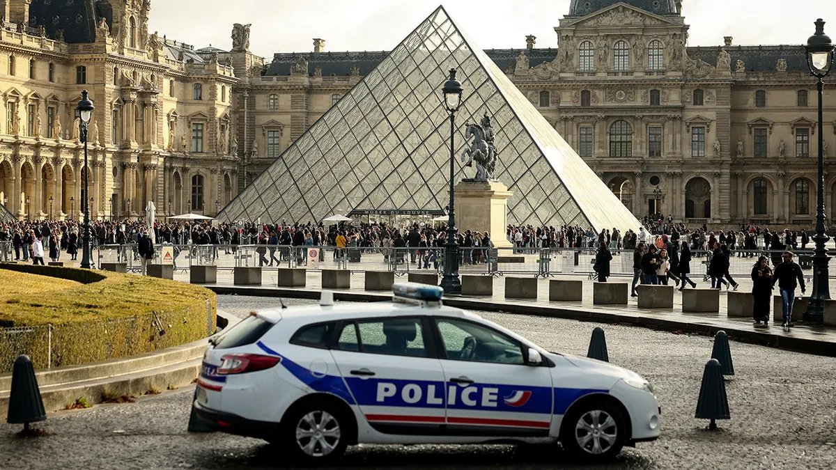 Visitors admiring art at the Louvre Museum.