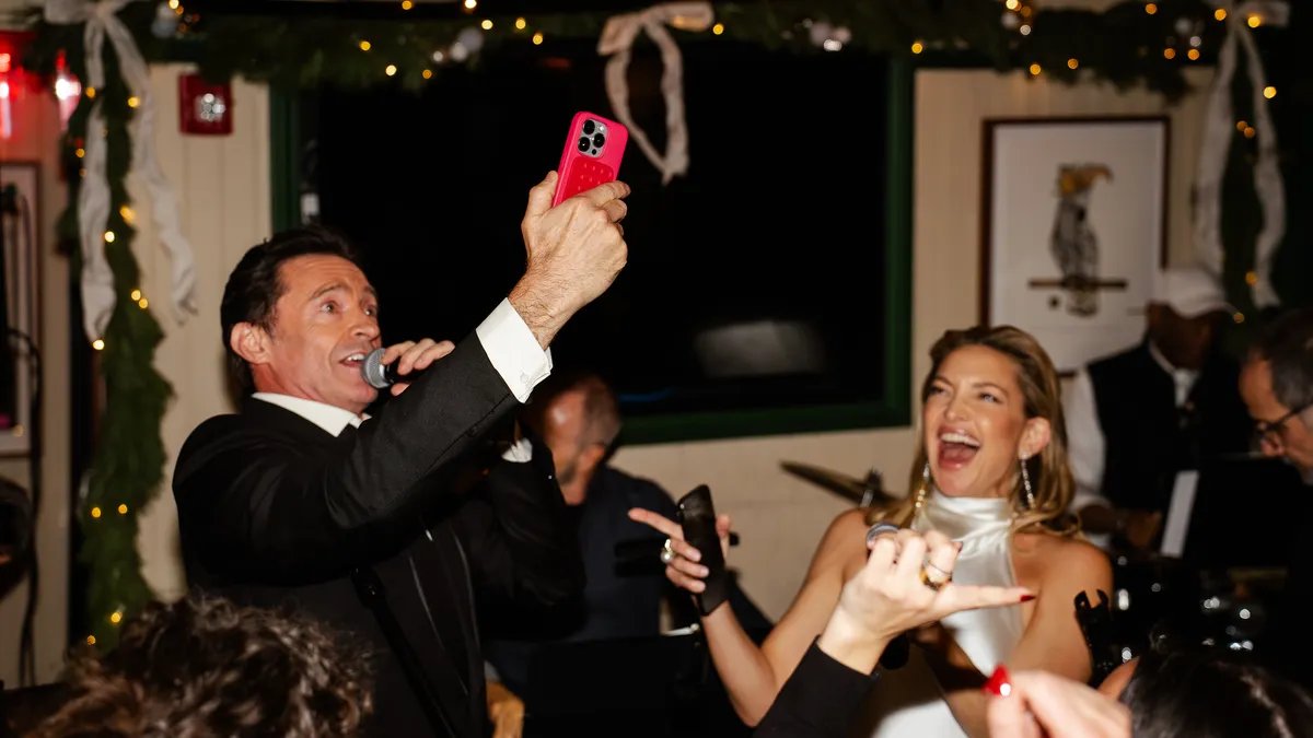 Hugh Jackman and Kate Hudson singing Sweet Caroline at an NYC bar.