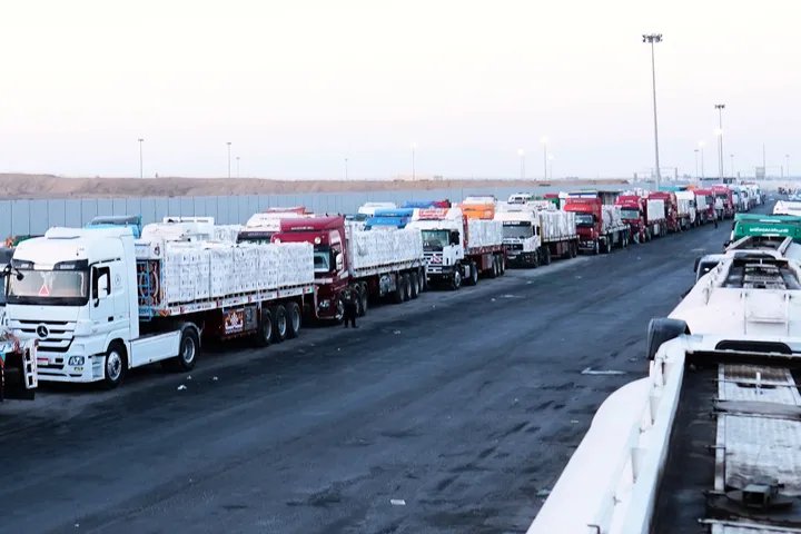 Palestinian civilians receiving aid at the Gaza border crossing after its reopening.