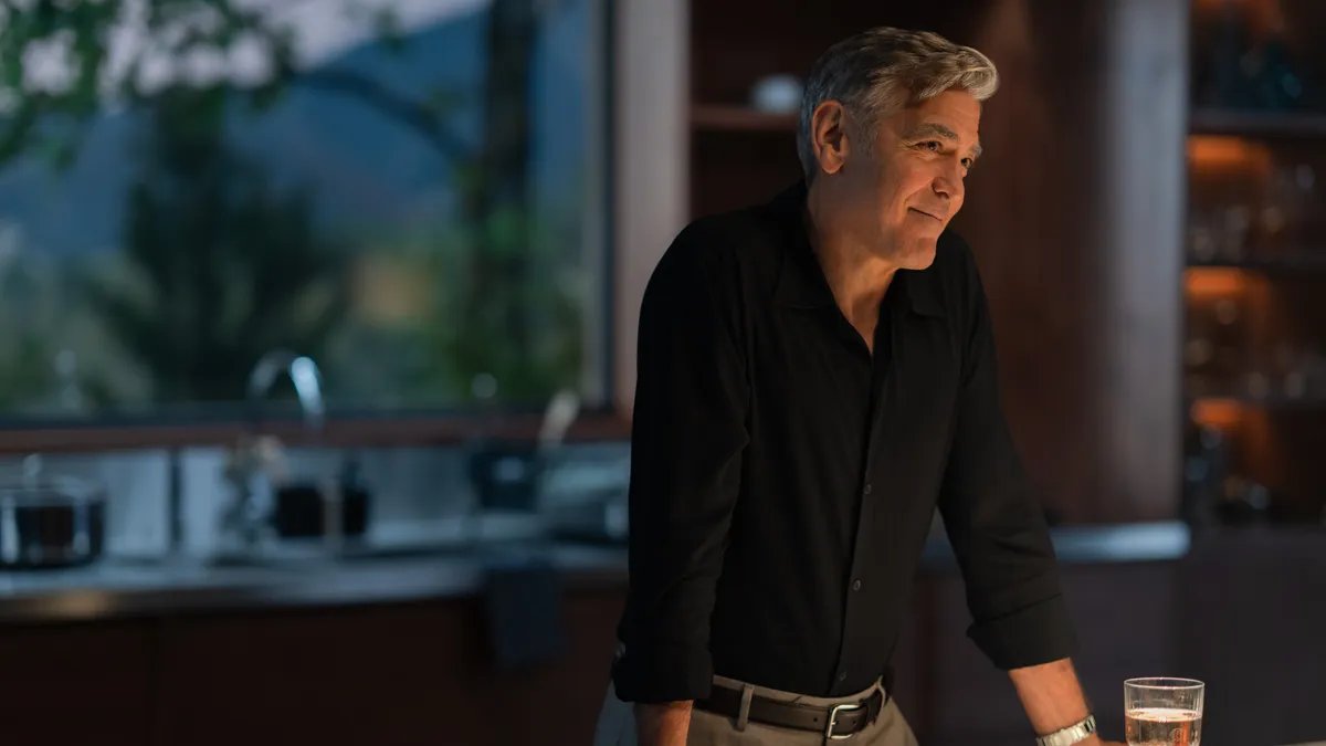 George Clooney in a dramatic scene from 'Jay Kelly' reflecting deep sorrow.