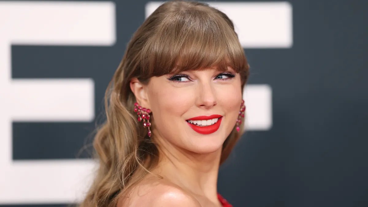 Taylor Swift speaking at a documentary screening, with a focused expression