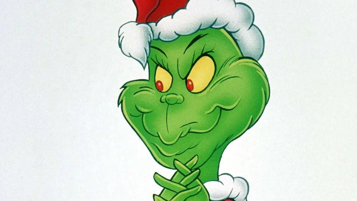 The iconic Grinch contemplating his next mischievous plan on Mount Crumpit, with Whoville lights twinkling below. He's looking down, a mischievous grin on his face, ready to steal Christmas.