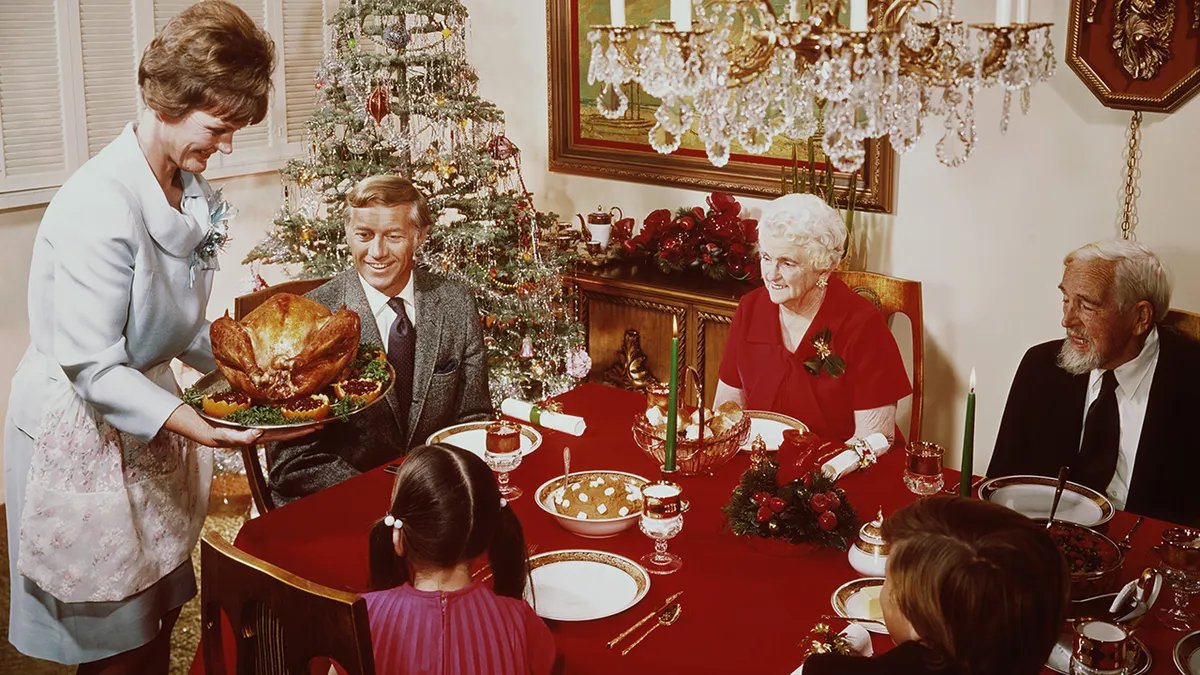 A rustic, traditional mincemeat pie, possibly showing a glimpse of the meat and fruit filling, on an antique wooden table.