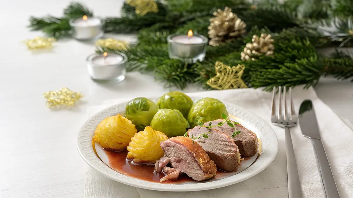 A vibrant, old-fashioned Ambrosia salad, featuring fresh orange segments, shredded coconut, and perhaps pecans, in a glass bowl.