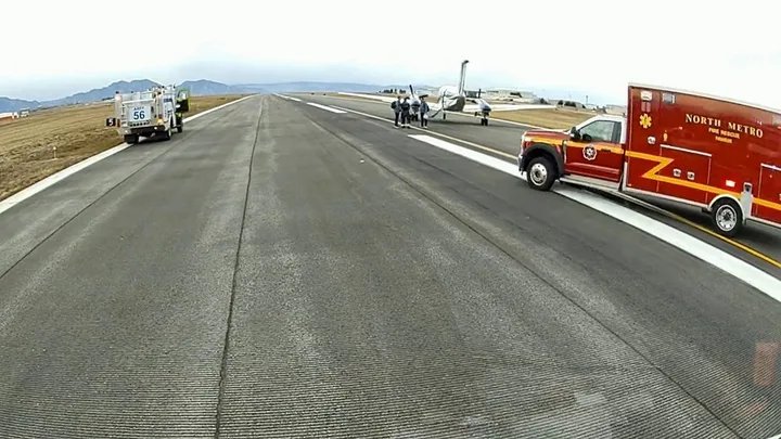 Cockpit view of an aircraft on final approach, with multiple screens displaying flight data and an autopilot engaged.