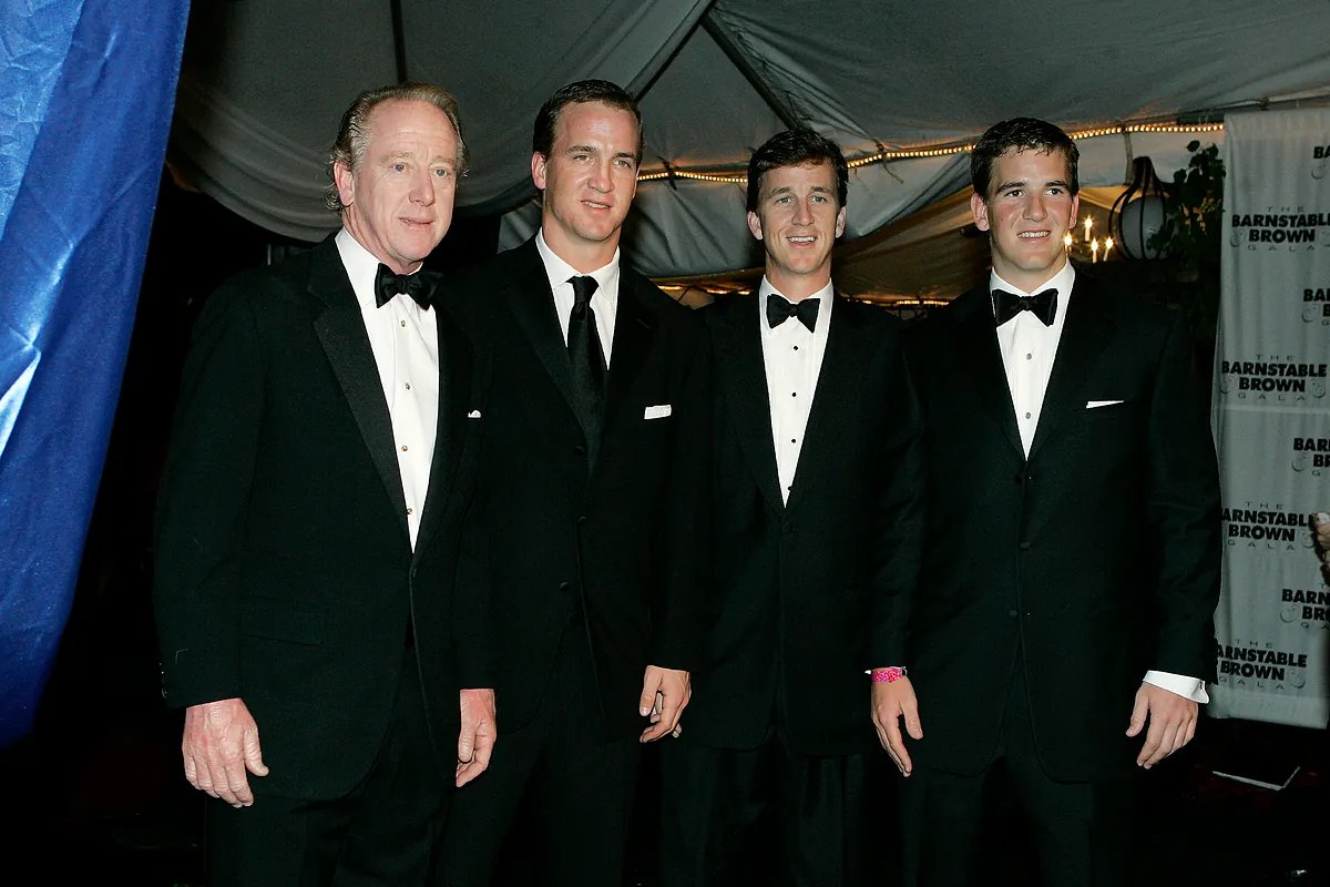Archie and Olivia Manning on their porch, smiling warmly.