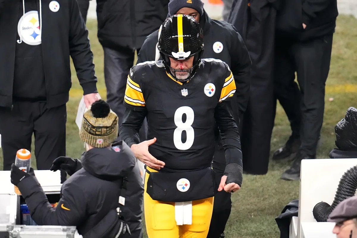 Aaron Rodgers grimaces in pain as he is helped off the field after suffering an injury.
