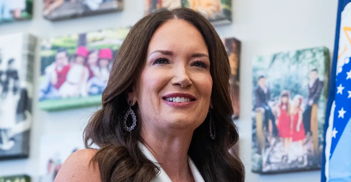 Eleanor Vance speaking at a political rally, with a mixed expression on her face.
