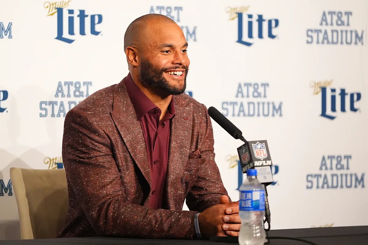Dak Prescott and Brian Schottenheimer on the sideline during a Cowboys game.