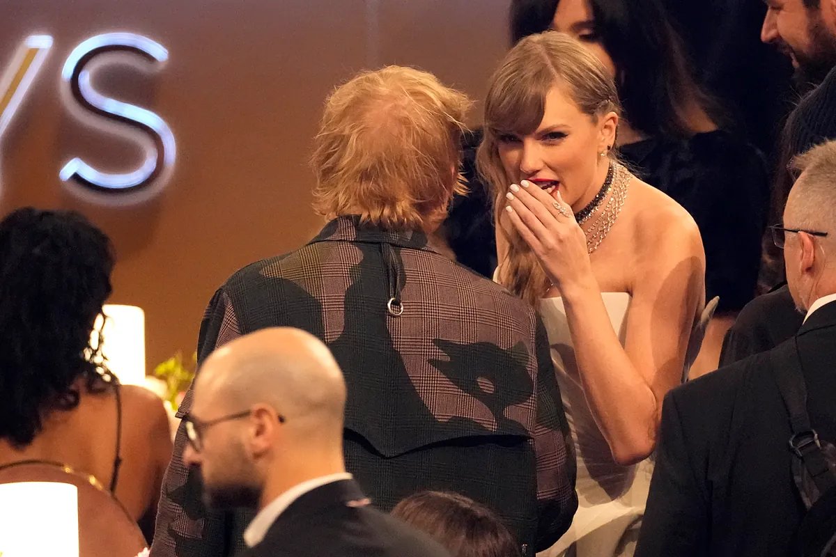 Ed Sheeran and Taylor Swift laughing together during an event.