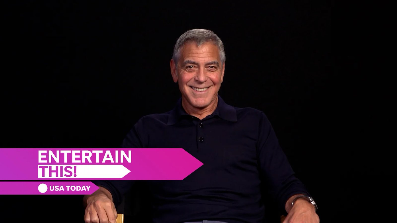 George Clooney in a contemplative pose during an interview.