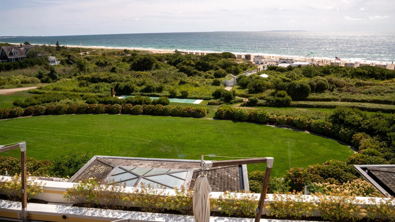 An aerial view of a grand estate nestled among trees, emphasizing its secluded and private nature, perfect for a celebrity wedding.
