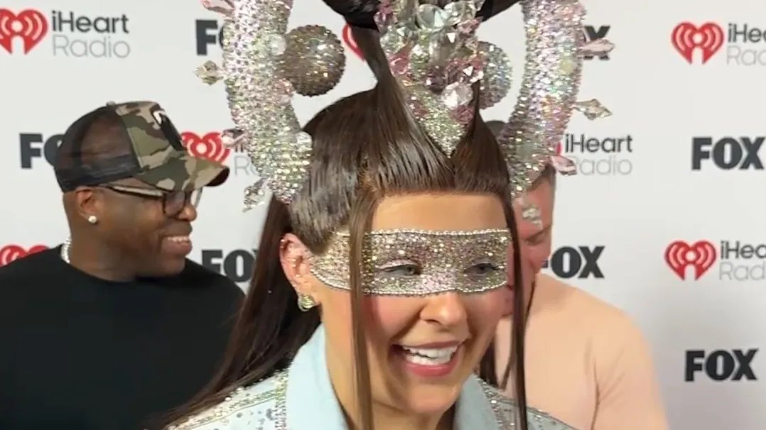 JoJo Siwa performing on stage, full of energy and smiles.