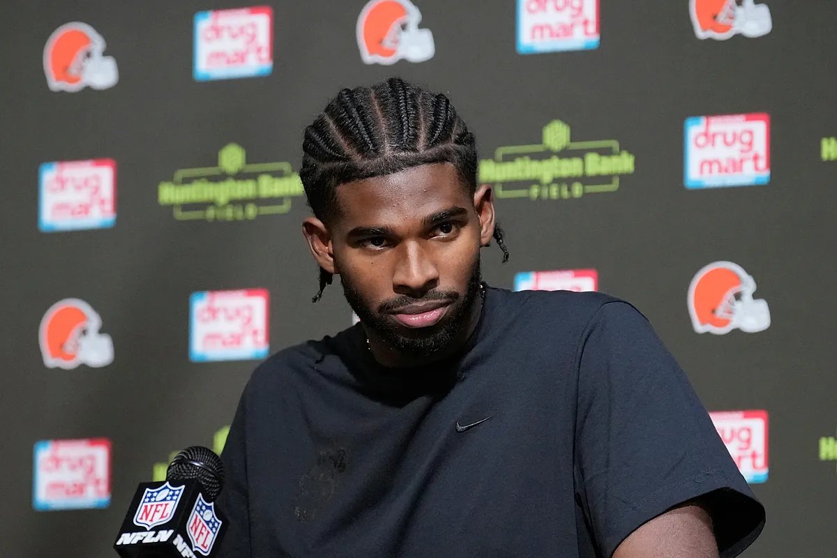 Michael Irvin and Shedeur Sanders sharing a laugh on the sidelines