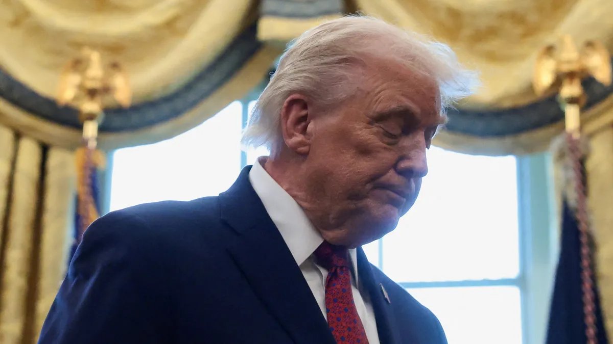 A somber individual looking at economic charts, representing the public's sour mood on the economy.