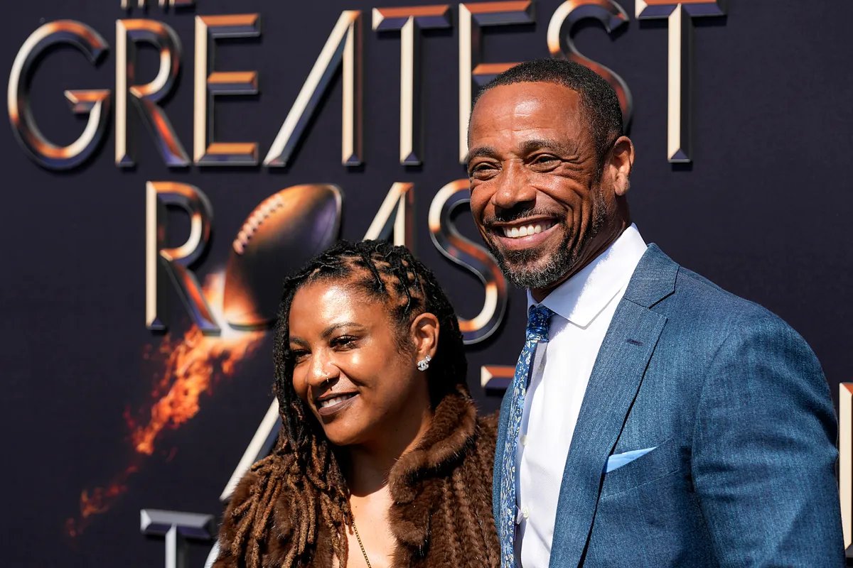 Rodney Harrison on the sidelines during a game, looking focused.