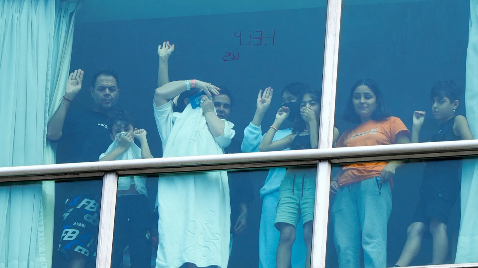 A family embraces tearfully at Tehran's airport, illustrating the emotional reunions following the arrival of deported Iranian nationals from the United States.