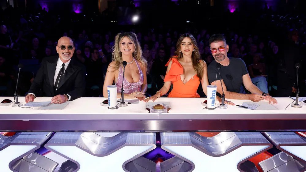 Simon Cowell smiling ironically.