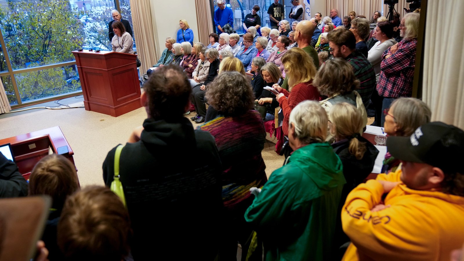 A close-up of a protest sign reading 'No ICE in Our Backyard'.