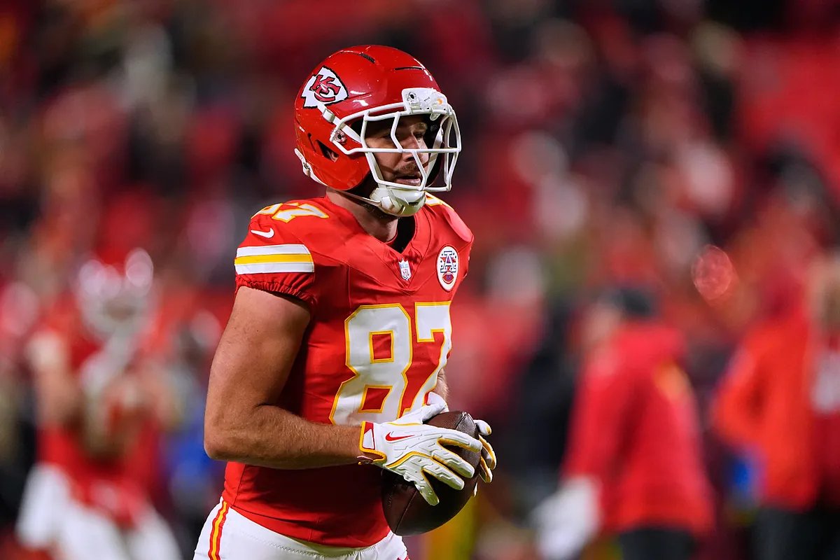 Travis Kelce waves to fans after a game, showcasing his immense popularity.