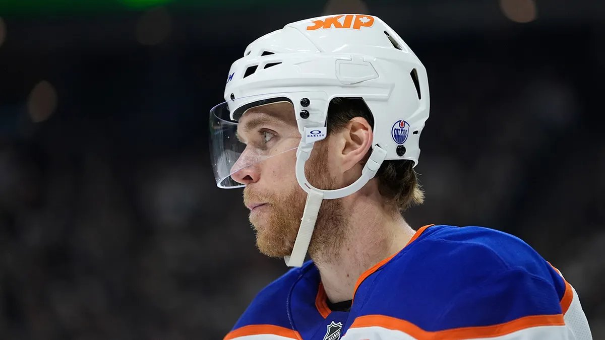 NHL star at a press conference, gesturing animatedly while explaining something.