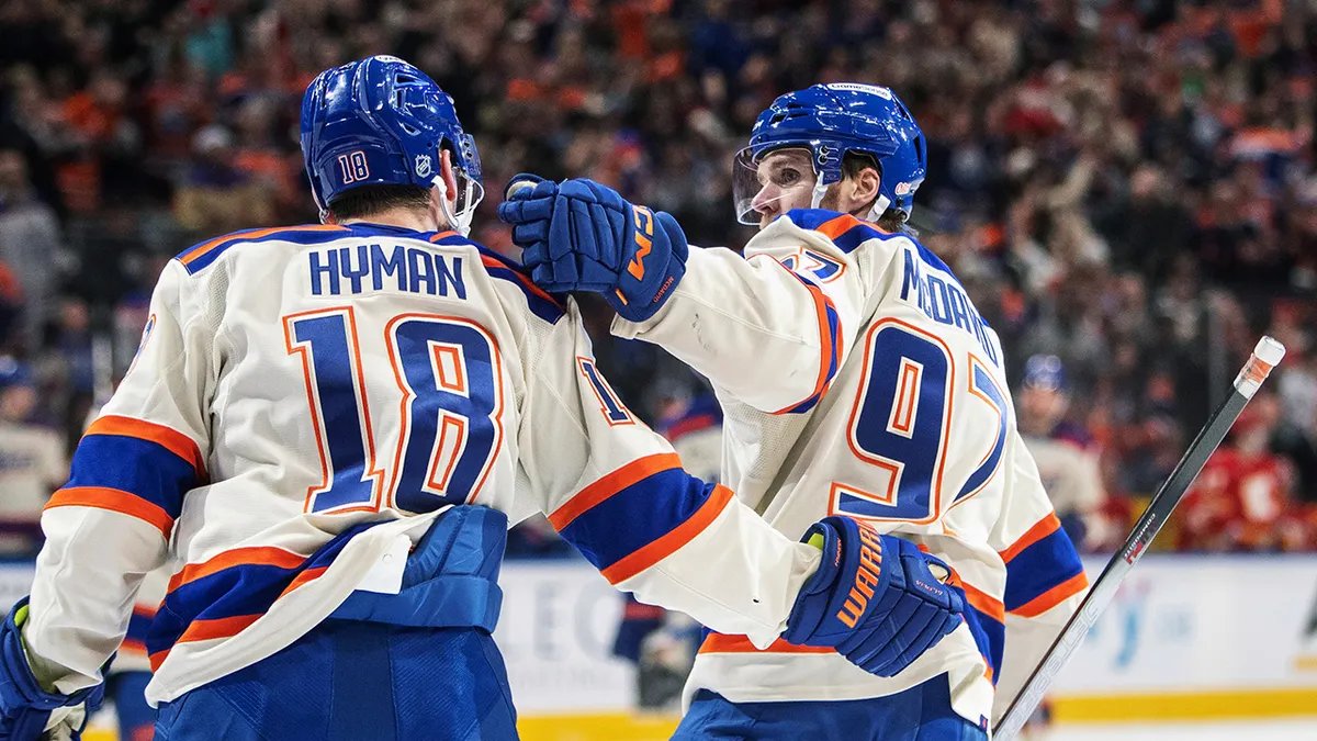 Teammates laughing good-naturedly in a locker room setting.