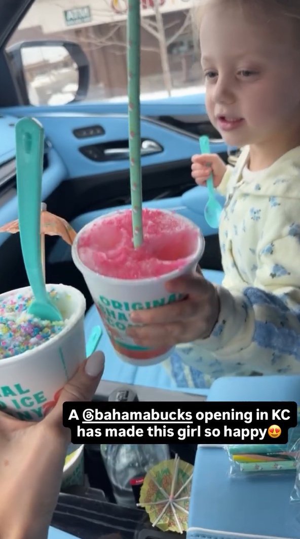 Brittany Mahomes, radiant with a wide smile, holds her daughter Sterling in a tender embrace, showcasing their close bond.