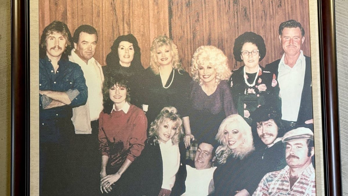 Dolly Parton with her family members at Dollywood in a vintage portrait