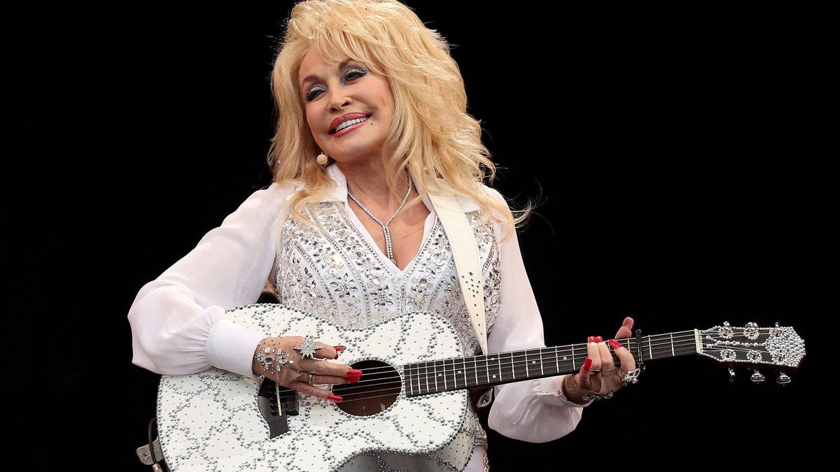 Dolly Parton performing on stage with microphone country music icon tribute