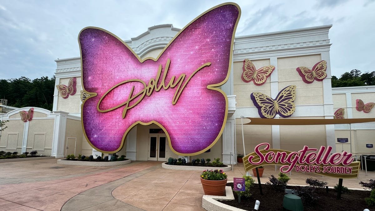 Songteller exhibit inside Dolly Parton Experience showcasing the rhinestone-covered Gibson guitar and personal memorabilia Songteller exhibit inside Dolly Parton Experience showcasing the rhinestone-covered Gibson guitar and personal memorabilia